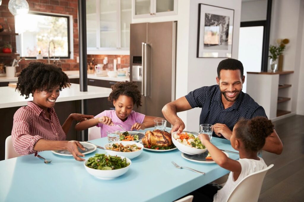 image of a family eating around the table