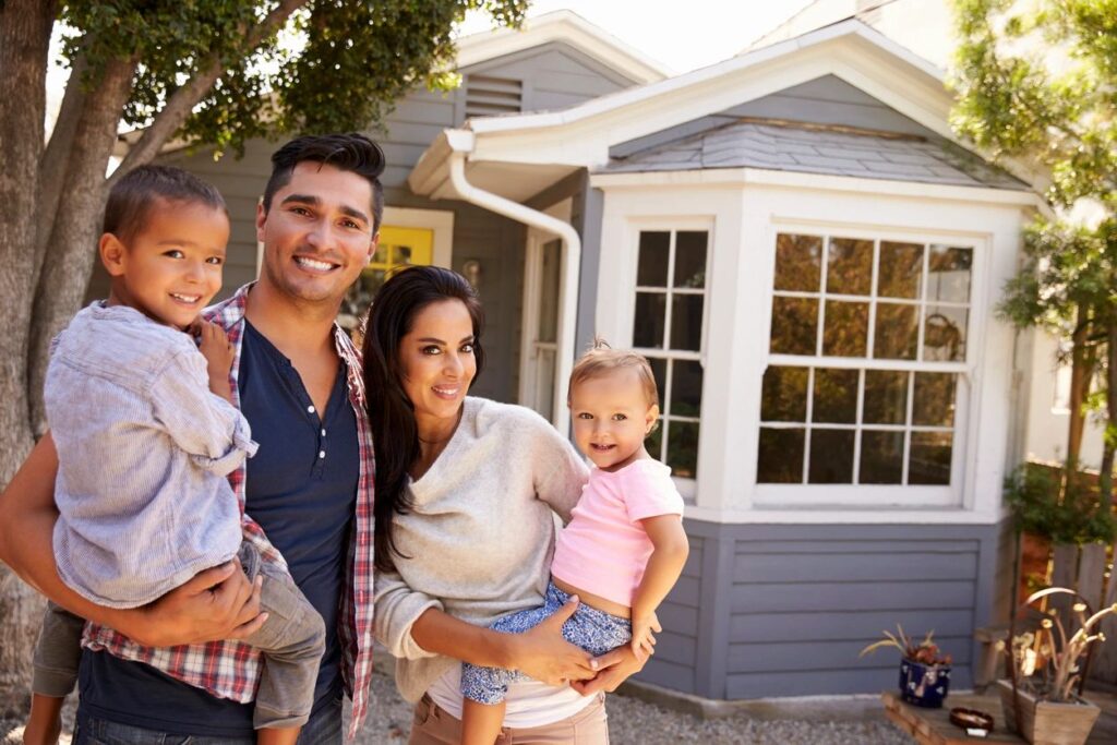 family in front of a house