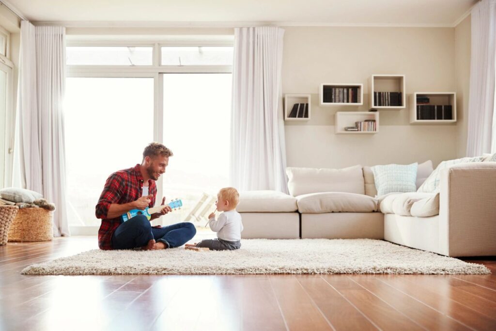 dad playing guitar for baby