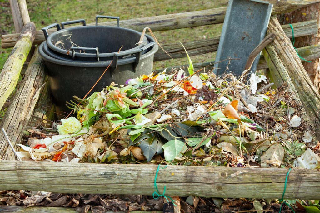 A compost pile with grass clippings, garden soil, and food scraps