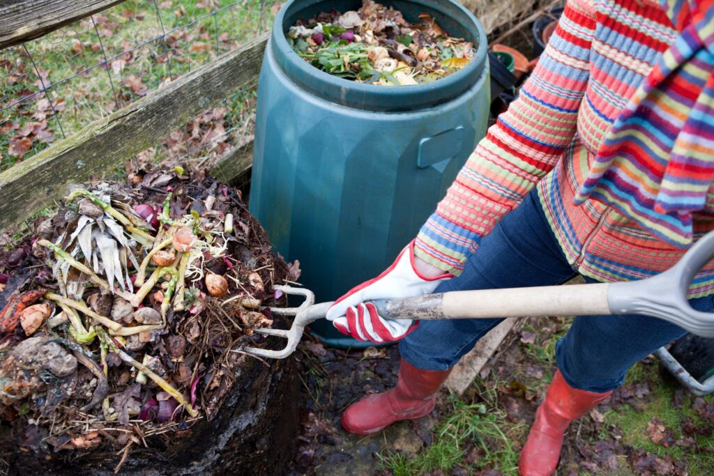 A compost container with compost heap and plant material