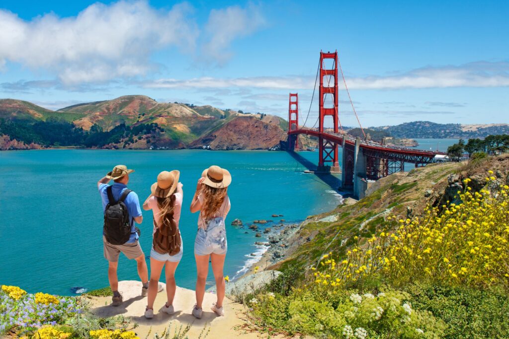 Three people looking out over a river