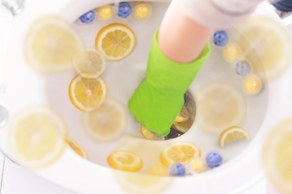 image of cleaning a toilet bowl with lemons