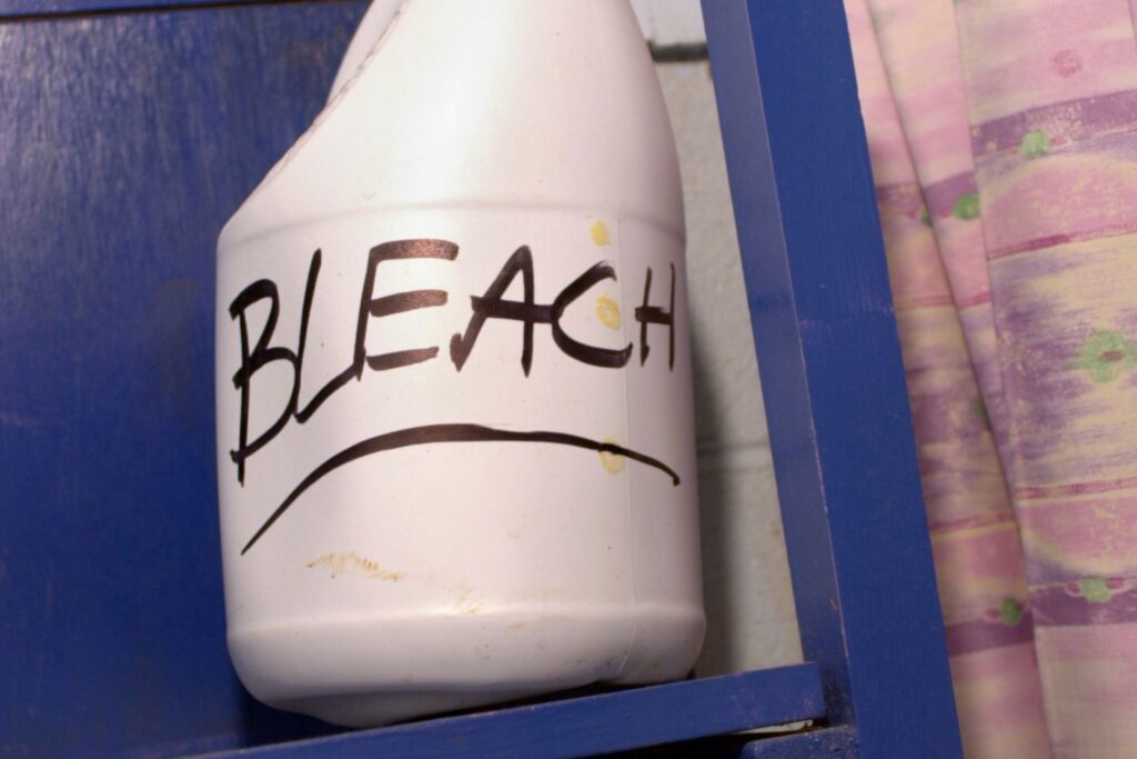 image of a white jug with the word "bleach" written in a black marker