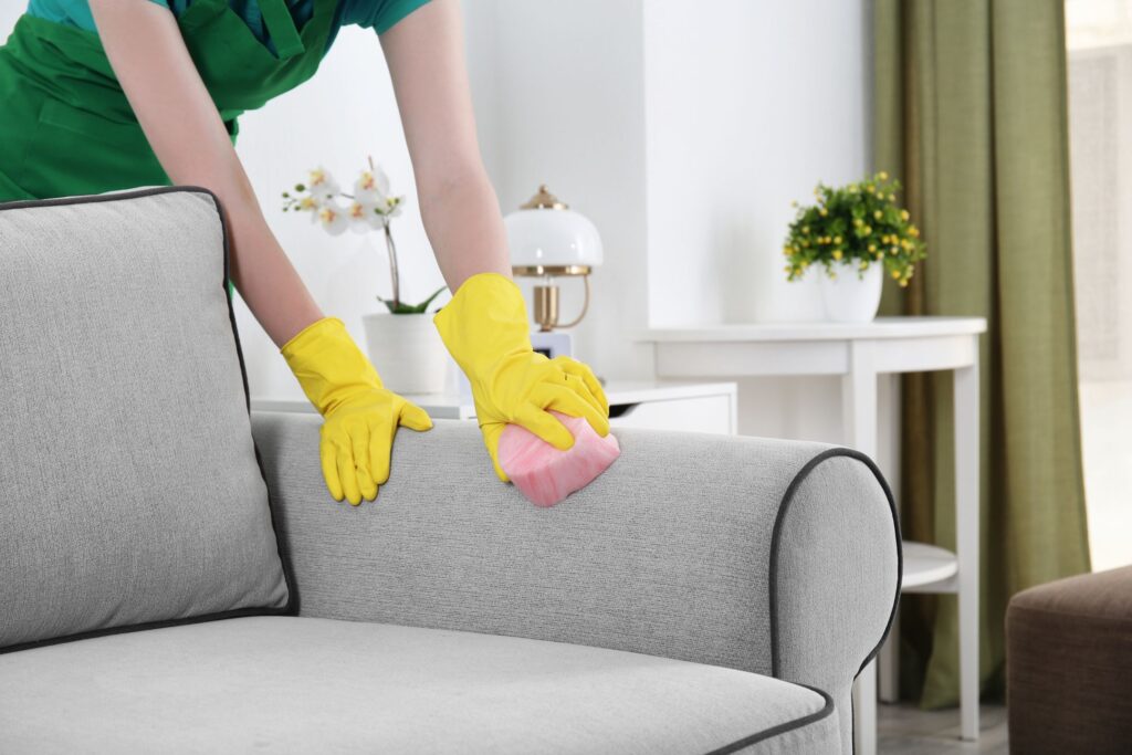 image of woman cleaning couch