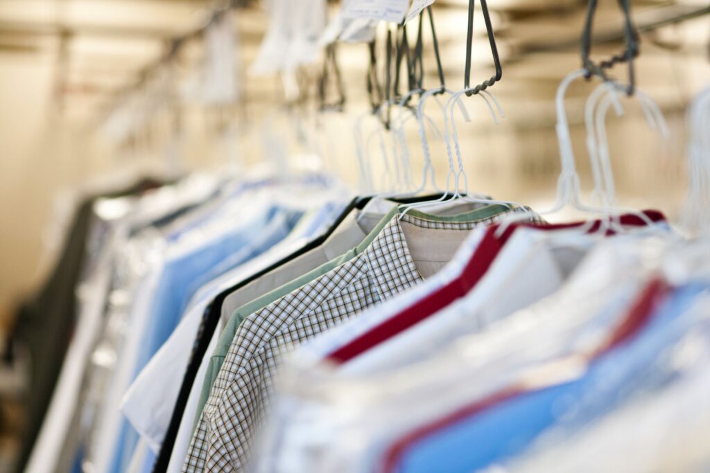 image of clothes hanging on a rack at the dry cleaners