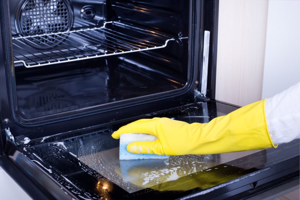 image of someone cleaning an oven