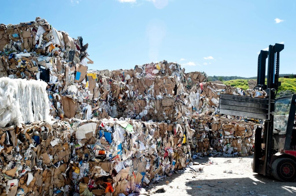 image of garbage being piled into cubes by a forklift