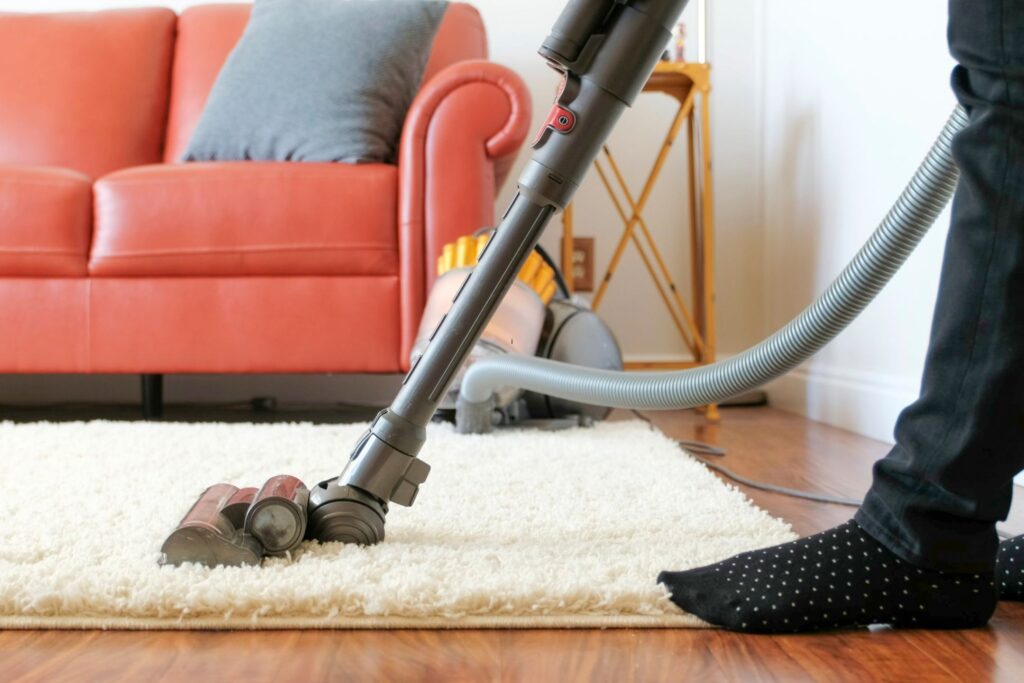 image of someone vacuuming a rug