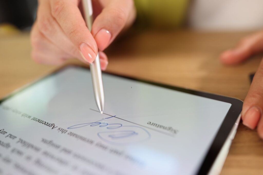 image of a woman signing a digital document