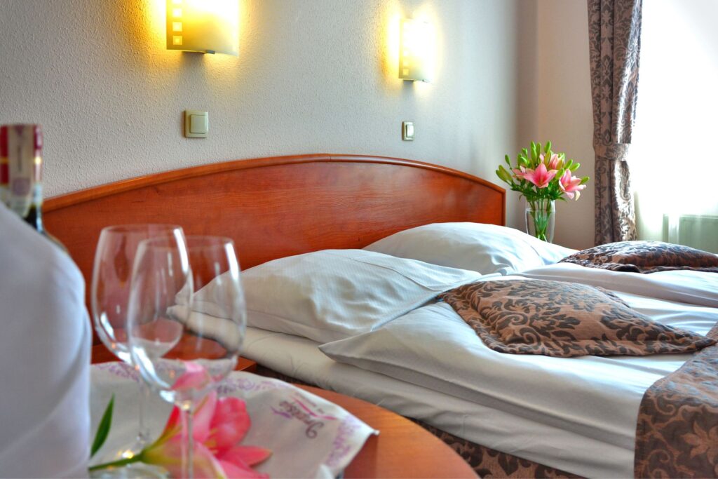 image of a beautiful hotel room with flowers and wine glasses