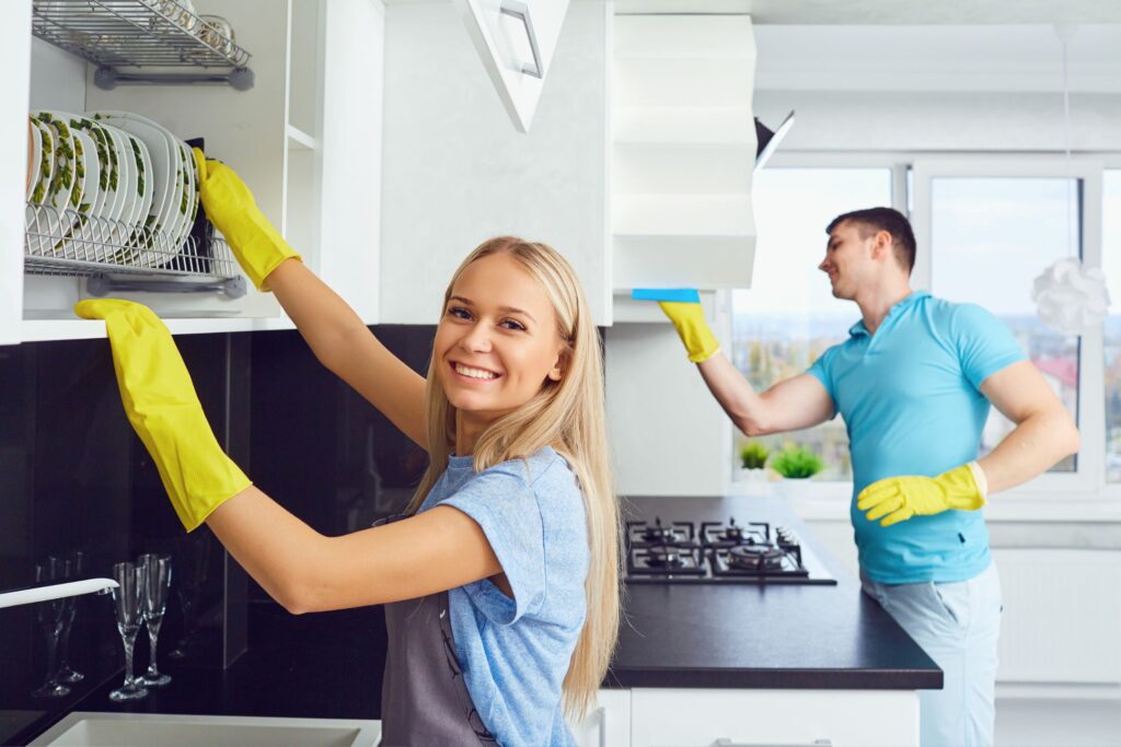 image of a man and a woman cleaning the kitchen