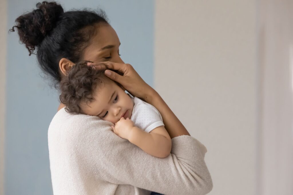 image of a mom snuggling baby