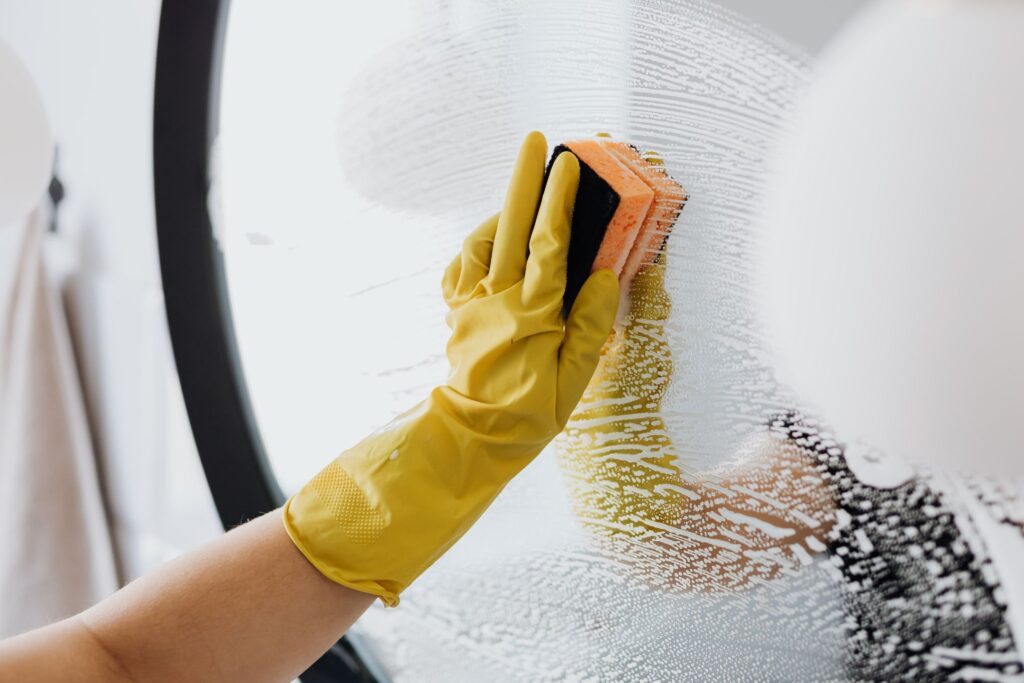 image of someone washing a mirror